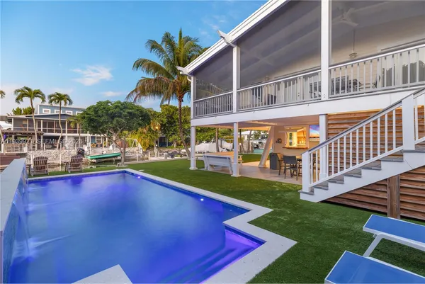 a view of an chairs and deck in the backyard