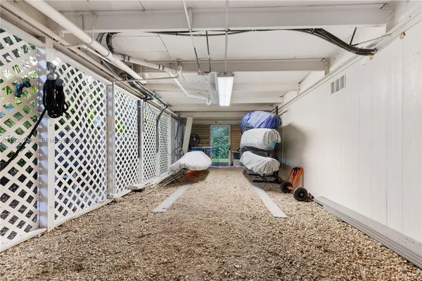 a view of a chairs and table in patio with a lake view