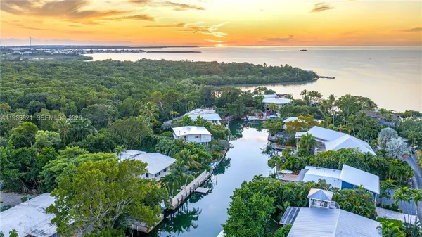 an aerial view of a house with garden space and lake view