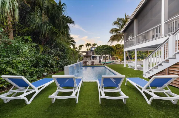 a view of a swimming pool with a table and chairs