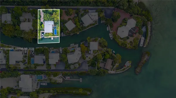 an aerial view of a house with garden space and lake view
