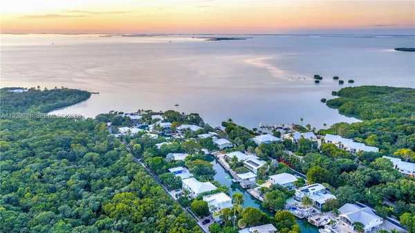 an aerial view of a house with garden space and lake view