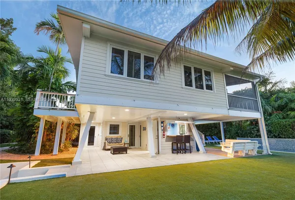 a view of a house with pool and chairs