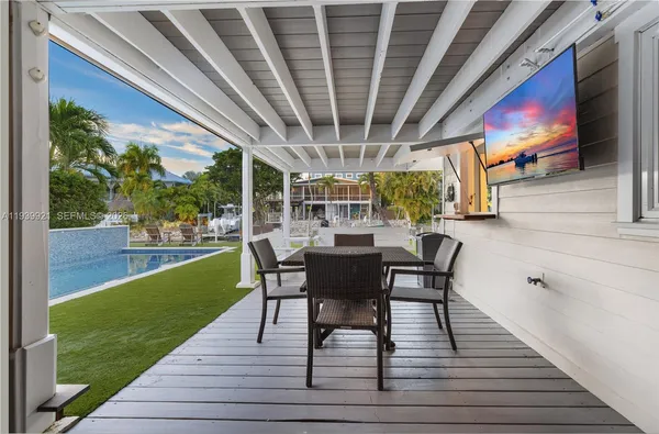 a view of a porch with furniture and a yard
