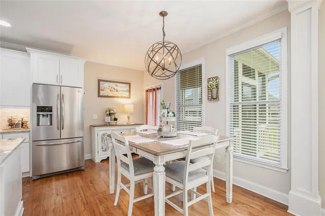 a kitchen with stainless steel appliances granite countertop a refrigerator and a stove top oven