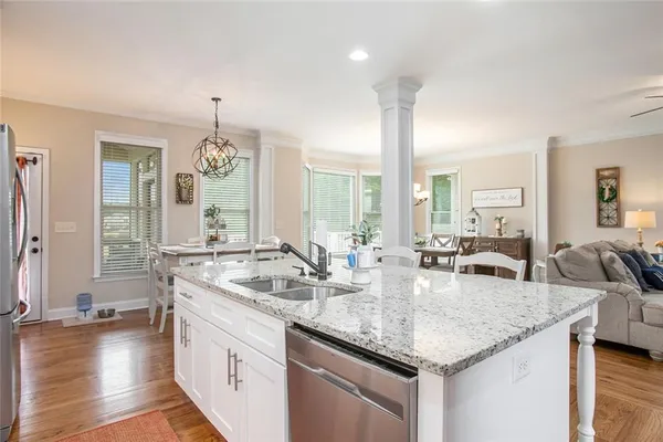 a en suite bathroom with a granite countertop sink and a mirror