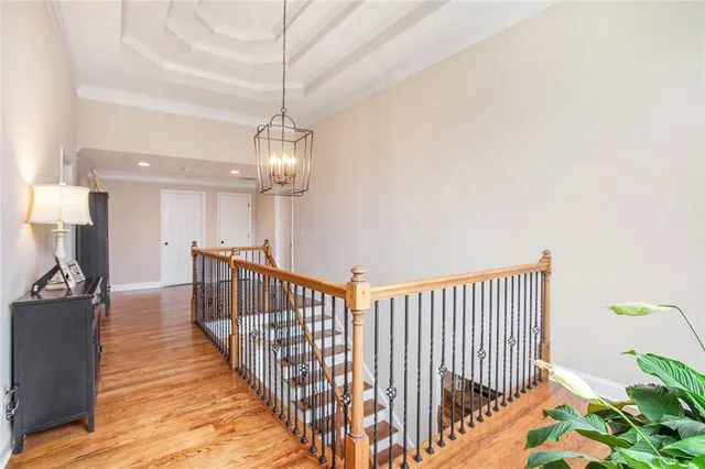 a spacious bedroom with a bed and wooden floor