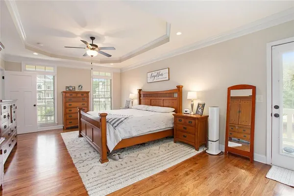 a bedroom with bed and a chandelier