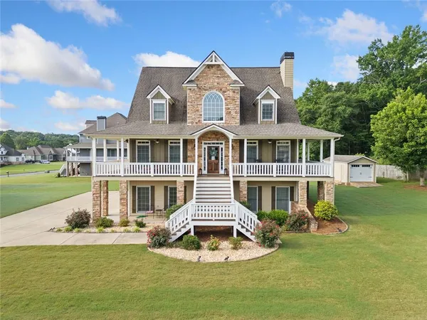 a front view of a house with swimming pool and garden