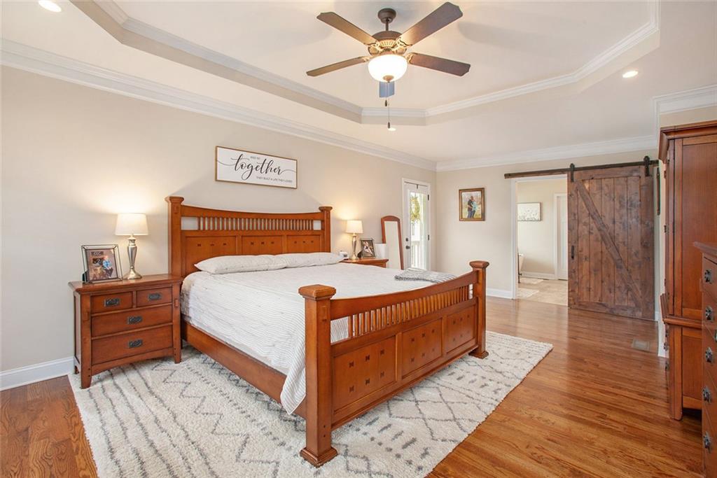 92 River Walk Parkway Euharlee, GA 30145 - Photo 21 of 53 a bedroom with bed and a chandelier