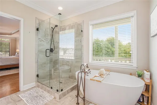 a spacious bedroom with a bed and a window