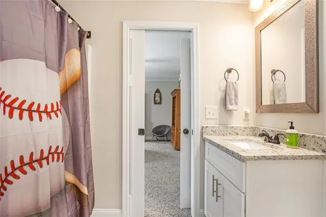 a bathroom with a granite countertop sink mirror and a