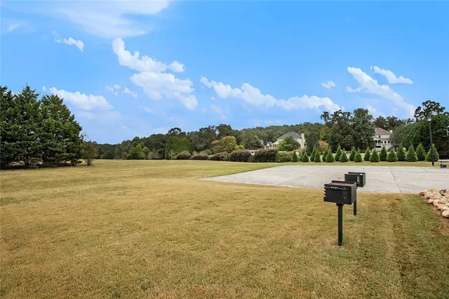 a view of a house with a yard and sitting area