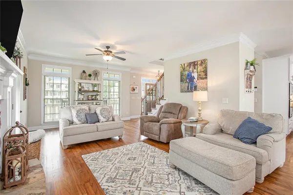 a living room with furniture a flat screen tv and a fireplace