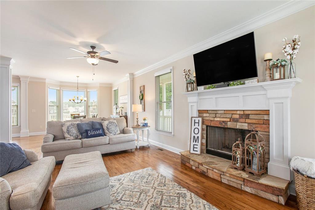 92 River Walk Parkway Euharlee, GA 30145 - Photo 9 of 53 a living room with furniture a flat screen tv and a fireplace
