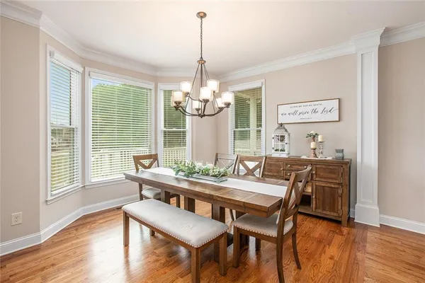 a view of a dining room with furniture window and wooden floor
