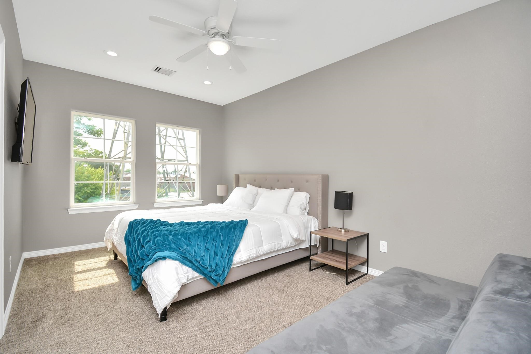 3019 Elysian Street Houston, TX 77009 - Photo 16 of 33 a spacious bedroom with a bed and a chandelier
