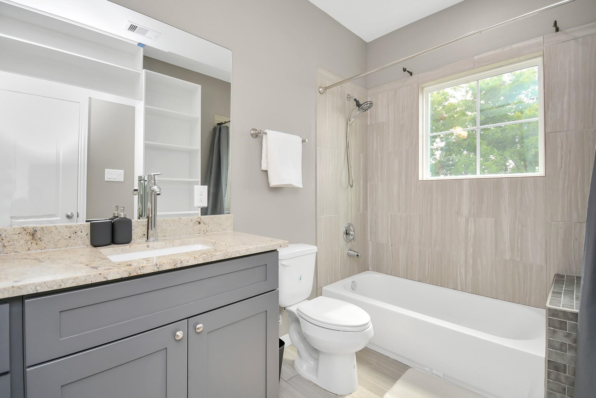 3019 Elysian Street Houston, TX 77009 - Photo 20 of 33 a bathroom with a granite countertop sink toilet and shower
