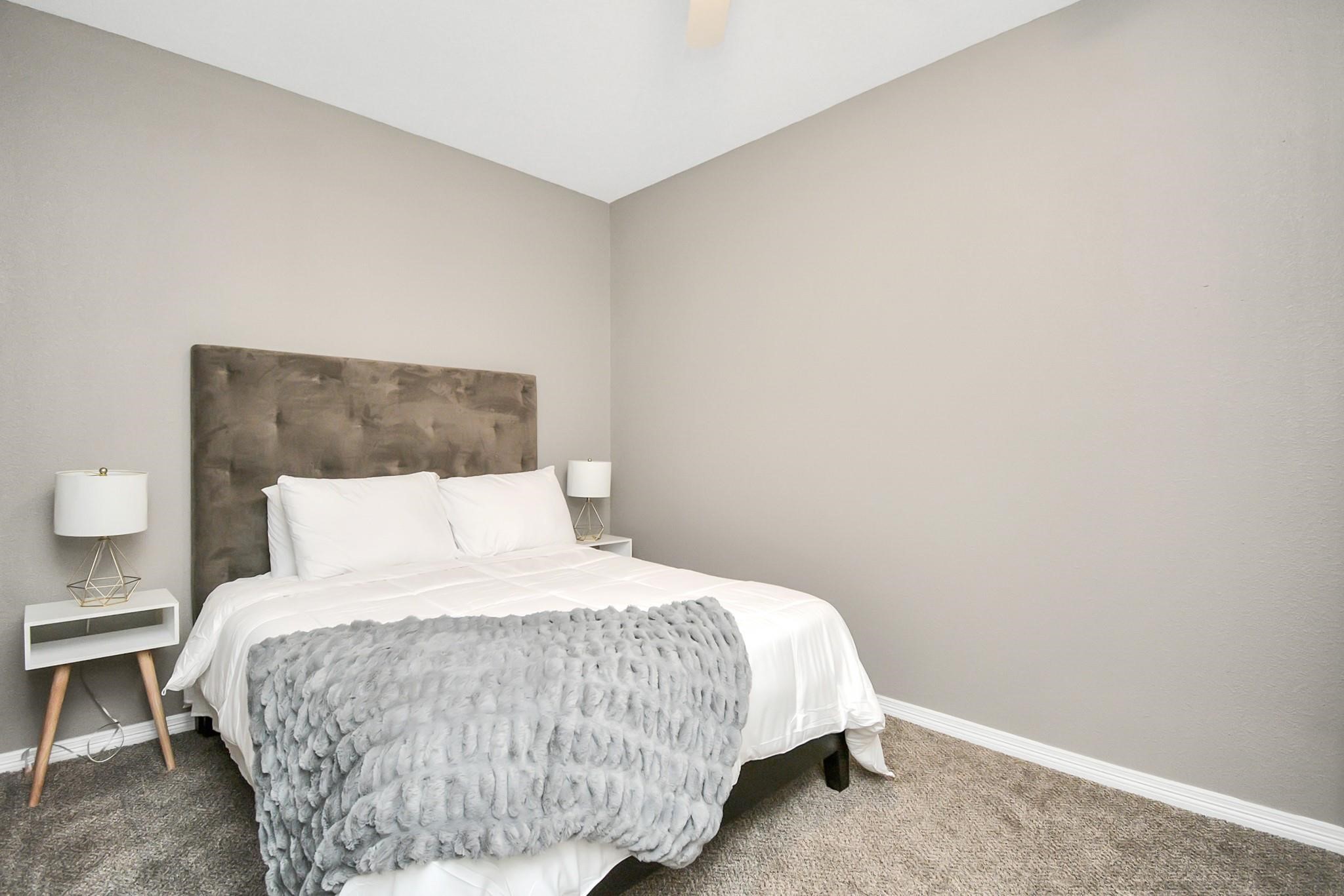 3019 Elysian Street Houston, TX 77009 - Photo 22 of 33 a large bed sitting in a bedroom next to a lamp