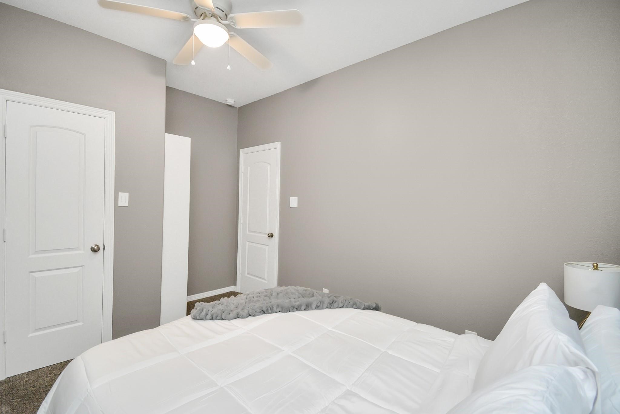 3019 Elysian Street Houston, TX 77009 - Photo 23 of 33 a bedroom with a bed and a chandelier