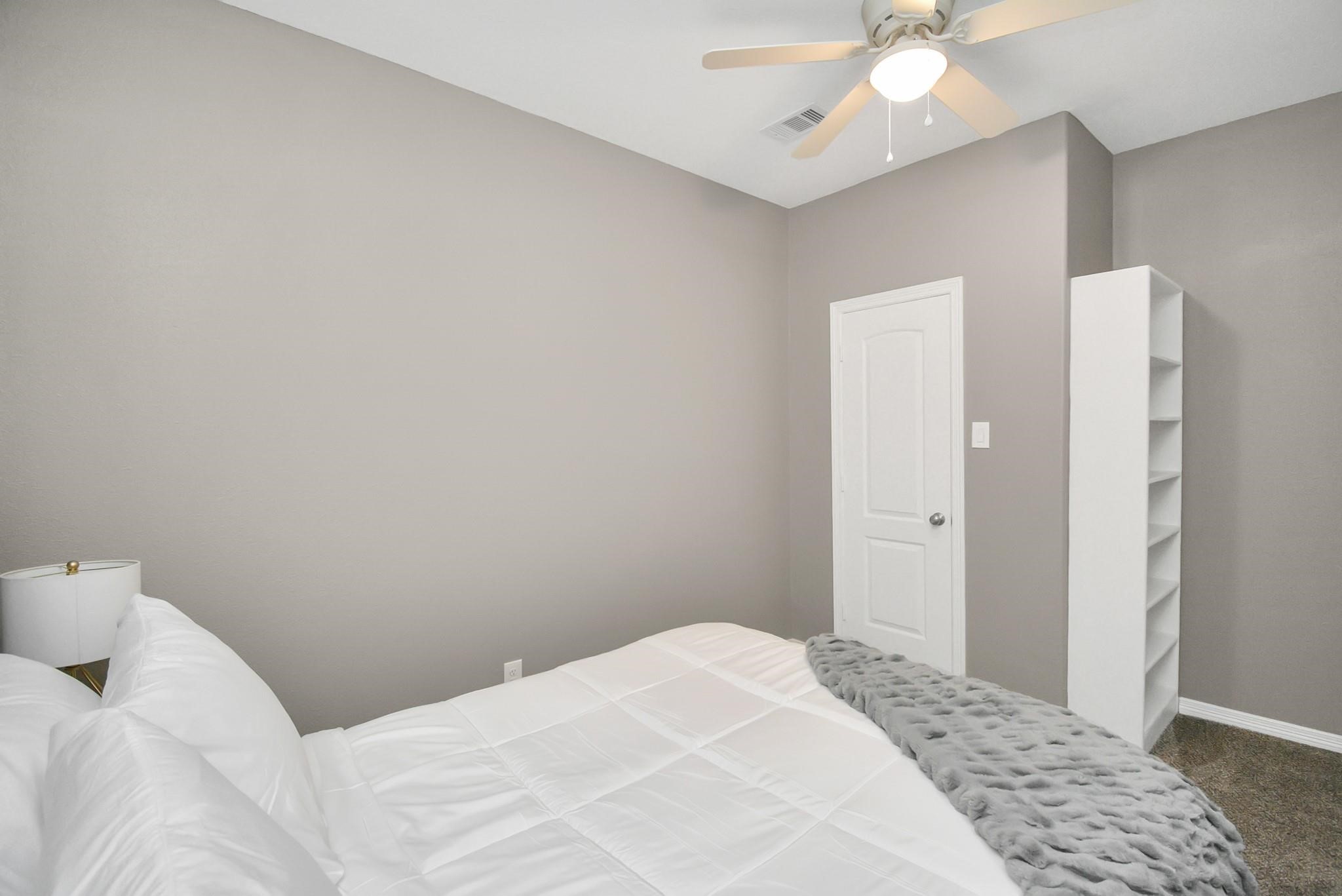 3019 Elysian Street Houston, TX 77009 - Photo 24 of 33 a bedroom with a bed and a chandelier