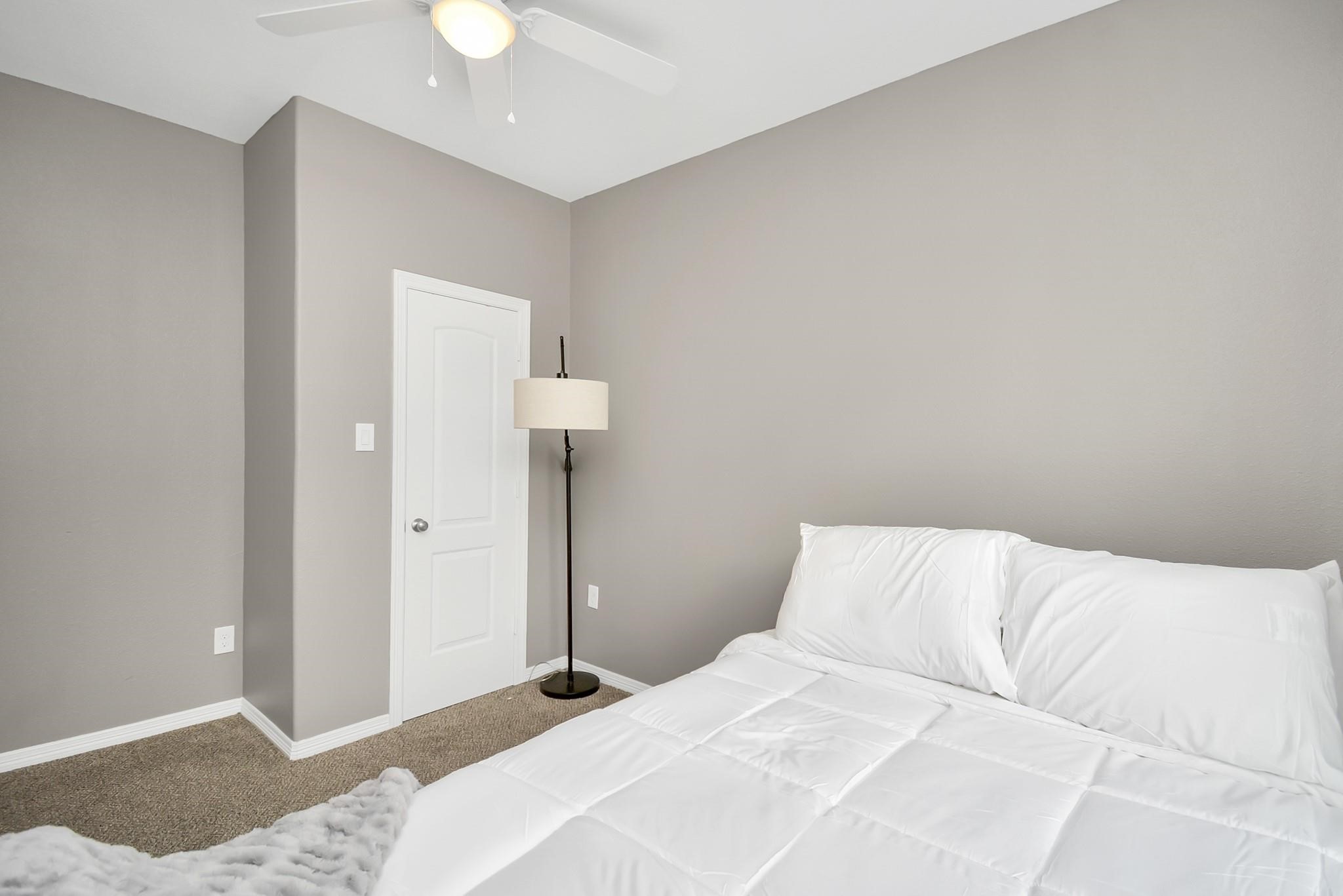 3019 Elysian Street Houston, TX 77009 - Photo 28 of 33 a bedroom with a bed and a chandelier