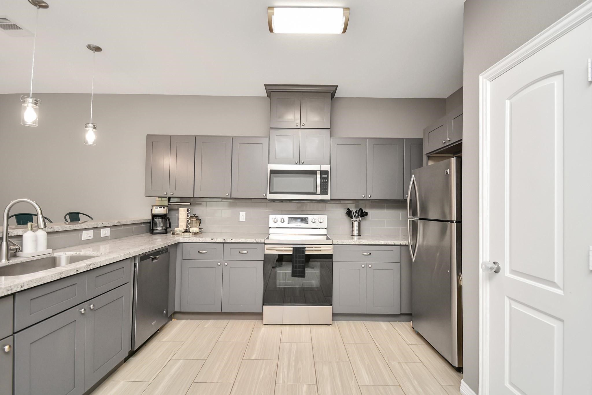 3019 Elysian Street Houston, TX 77009 - Photo 8 of 33 a kitchen with stainless steel appliances granite countertop a sink stove and refrigerator