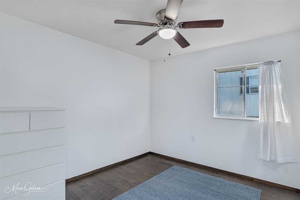 3304 Gorton Road Shreveport, LA 71119 - Photo 15 of 21 an empty room with a chandelier fan and windows