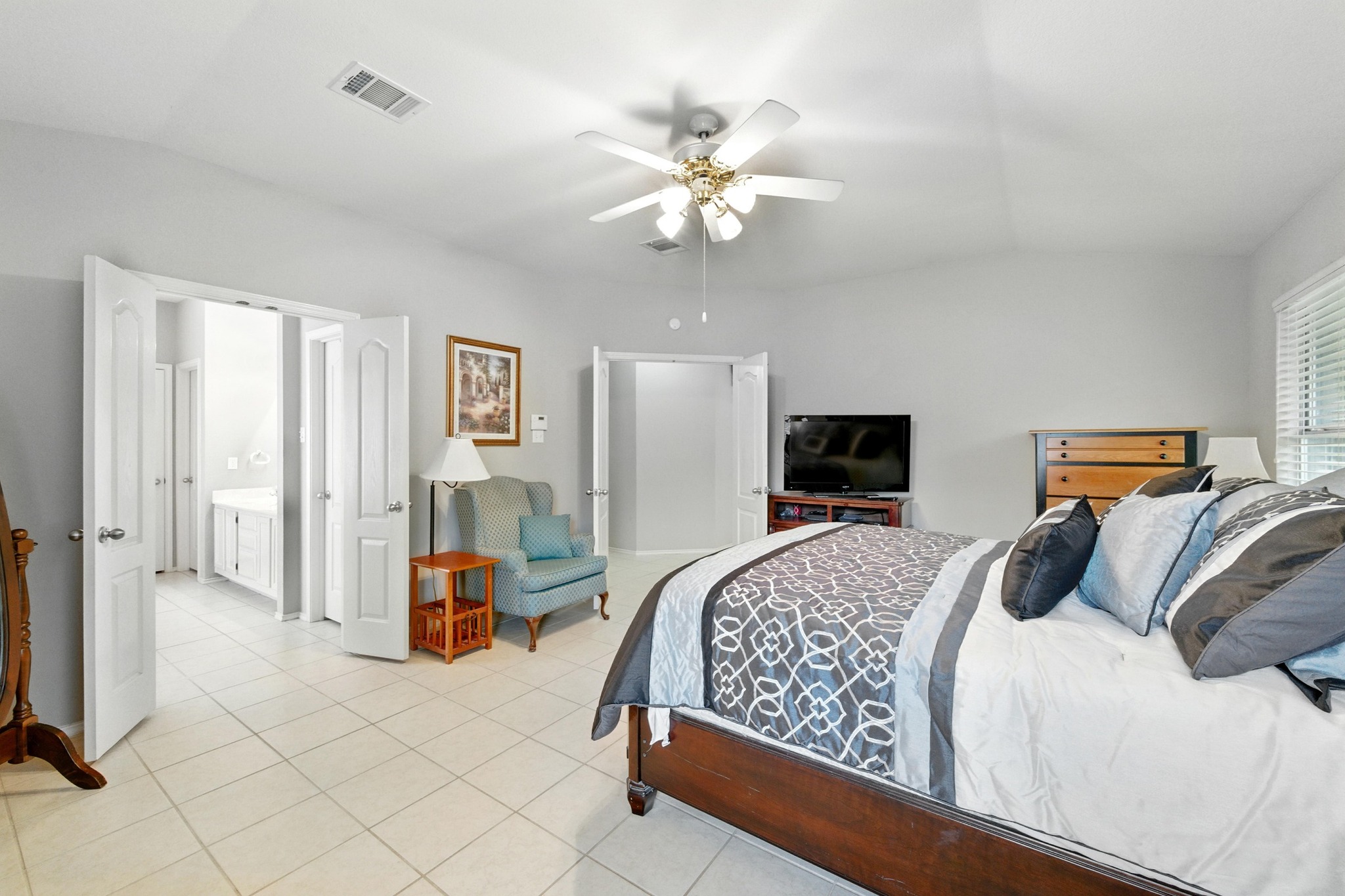 9602 Tea Rose Trail Austin, TX 78748 - Photo 17 of 27 Bedroom with vaulted ceiling, ceiling fan, and light tile patterned flooring