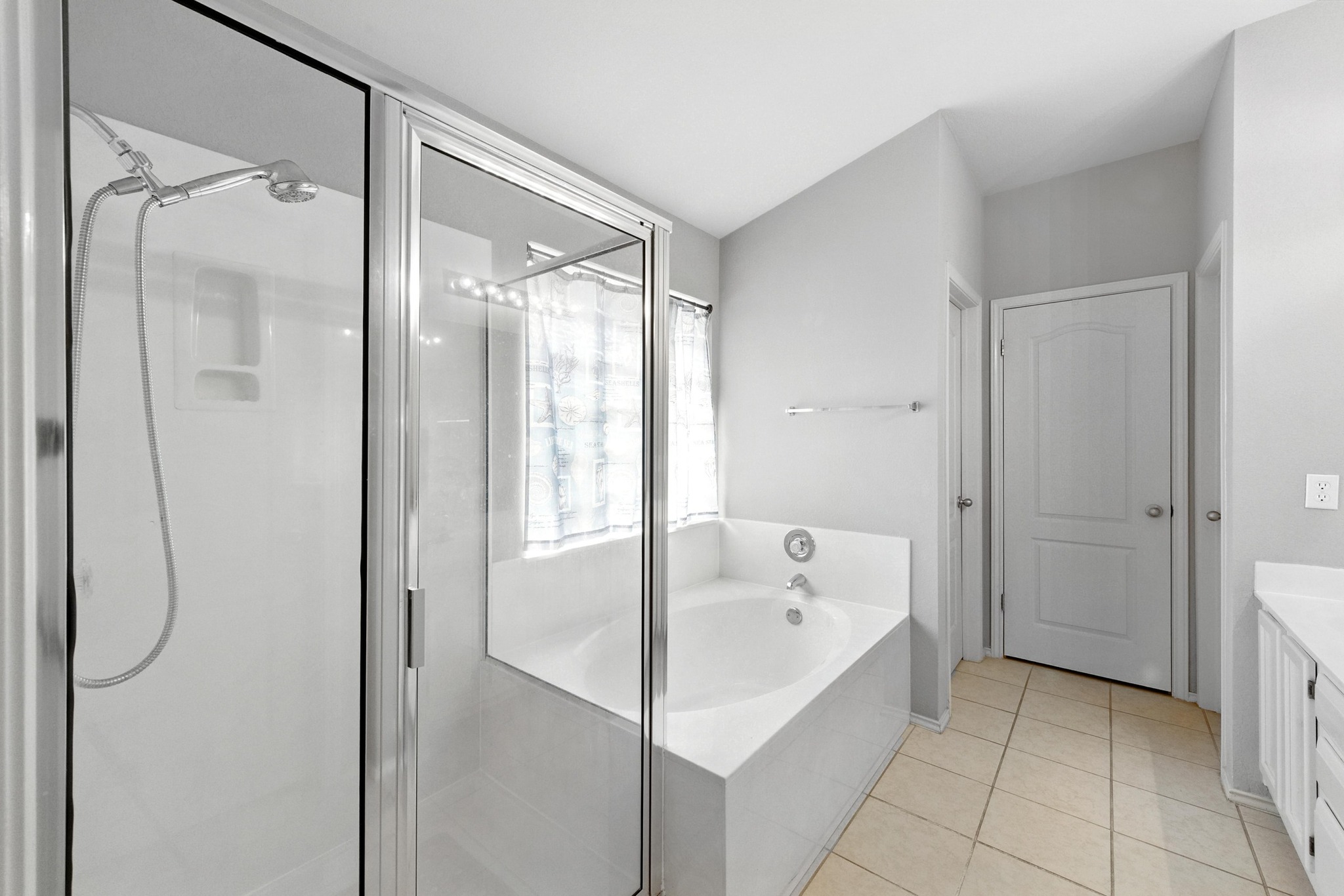 9602 Tea Rose Trail Austin, TX 78748 - Photo 18 of 27 Bathroom with vanity, a shower stall, a bath, and light tile patterned floors
