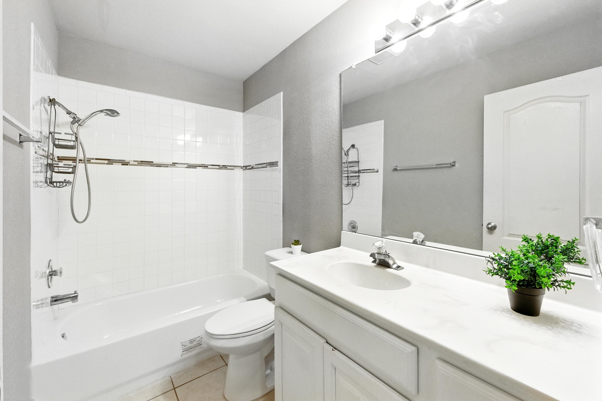 9602 Tea Rose Trail Austin, TX 78748 - Photo 22 of 27 Bathroom with vanity, light tile patterned flooring, and shower / tub combination