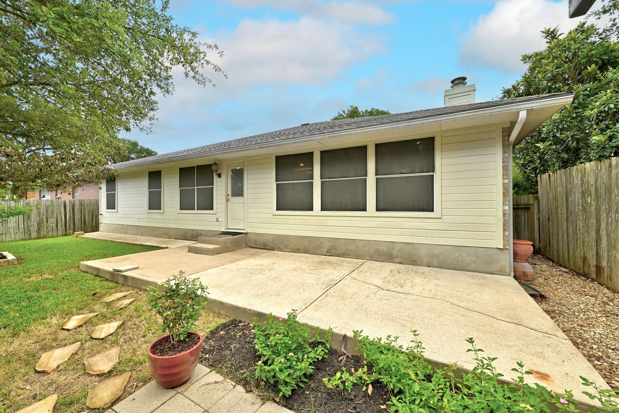 9602 Tea Rose Trail Austin, TX 78748 - Photo 24 of 27 Back of house featuring a chimney and a patio