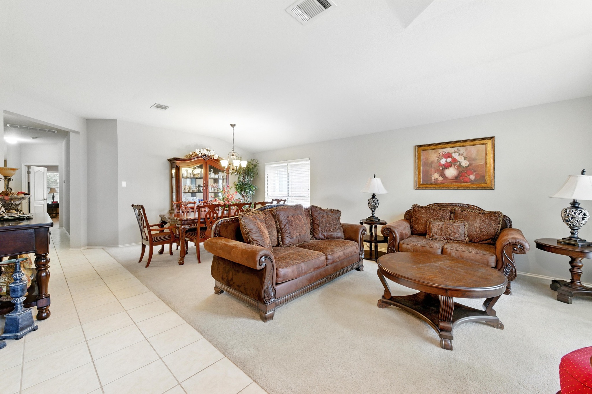 9602 Tea Rose Trail Austin, TX 78748 - Photo 3 of 27 Living area with light colored carpet, light tile patterned floors, and hanging lights