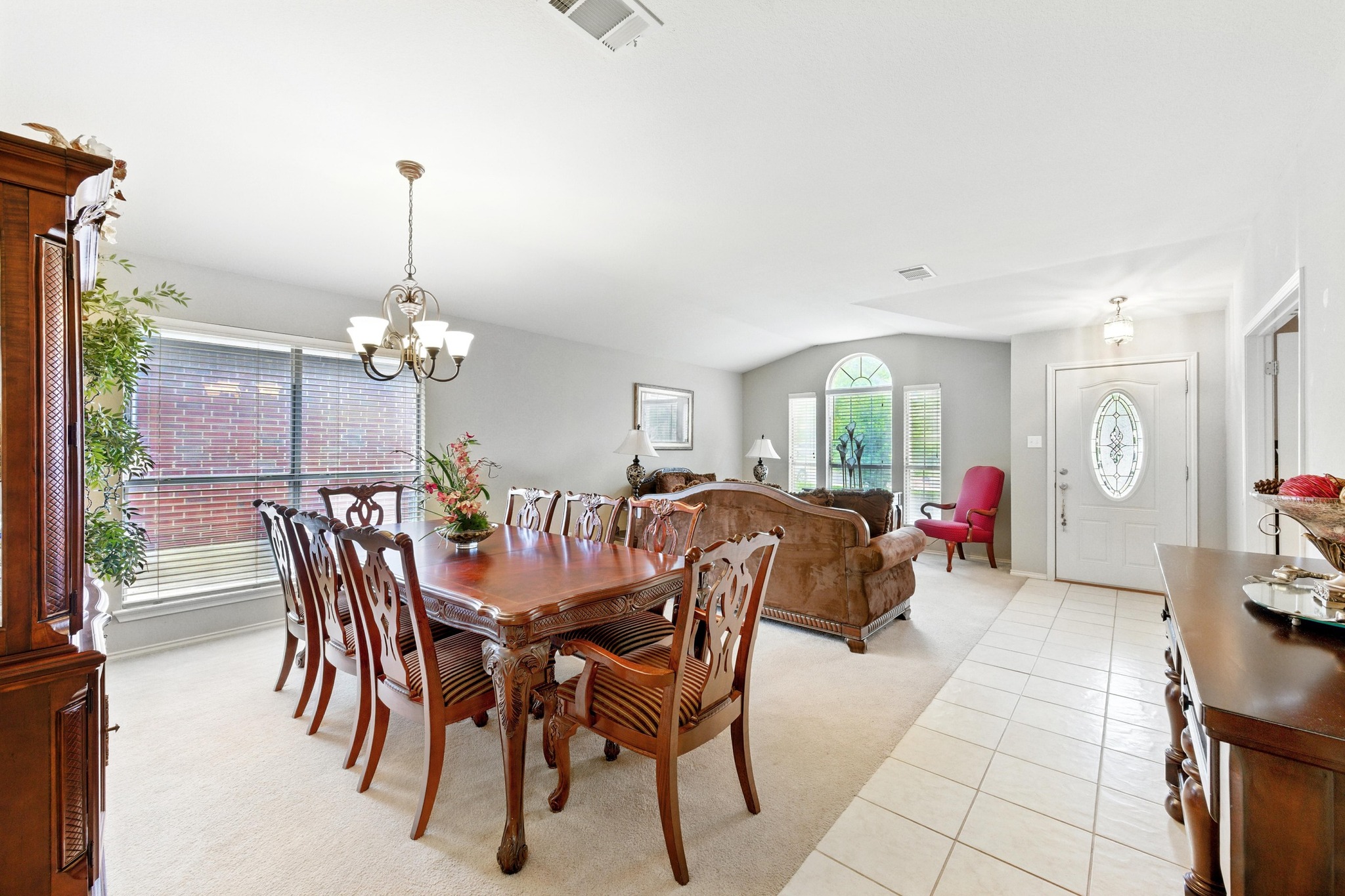 9602 Tea Rose Trail Austin, TX 78748 - Photo 6 of 27 Dining space with light carpet, vaulted ceiling, a chandelier, and light tile patterned floors