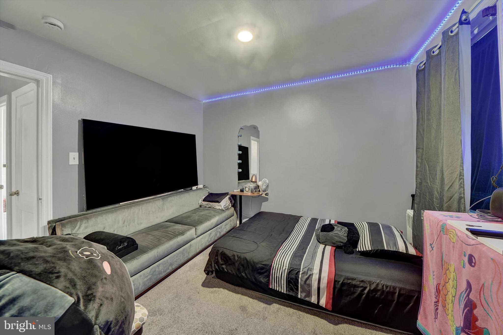 3552 Benzinger Road Baltimore, MD 21229 - Photo 11 of 23 a bedroom with a bed and a flat screen tv