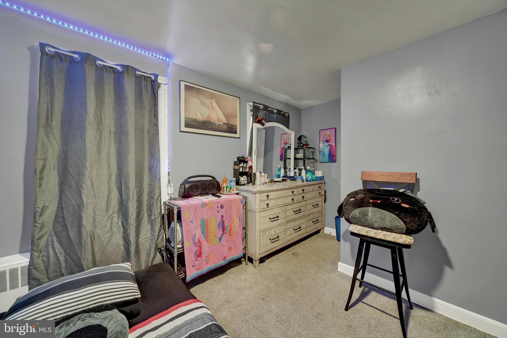 3552 Benzinger Road Baltimore, MD 21229 - Photo 12 of 23 a bedroom with a bed and a chandelier