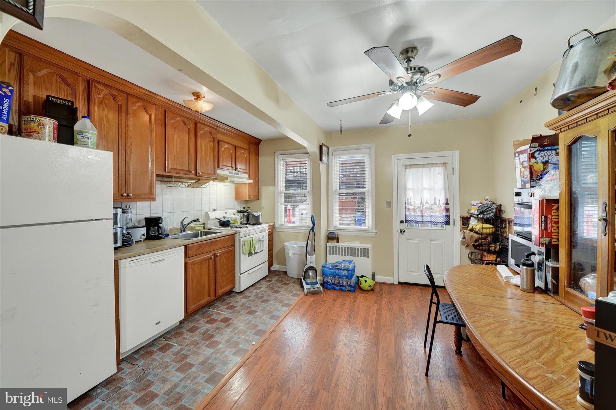 3552 Benzinger Road Baltimore, MD 21229 - Photo 6 of 23 a kitchen with sink a refrigerator and wooden floor