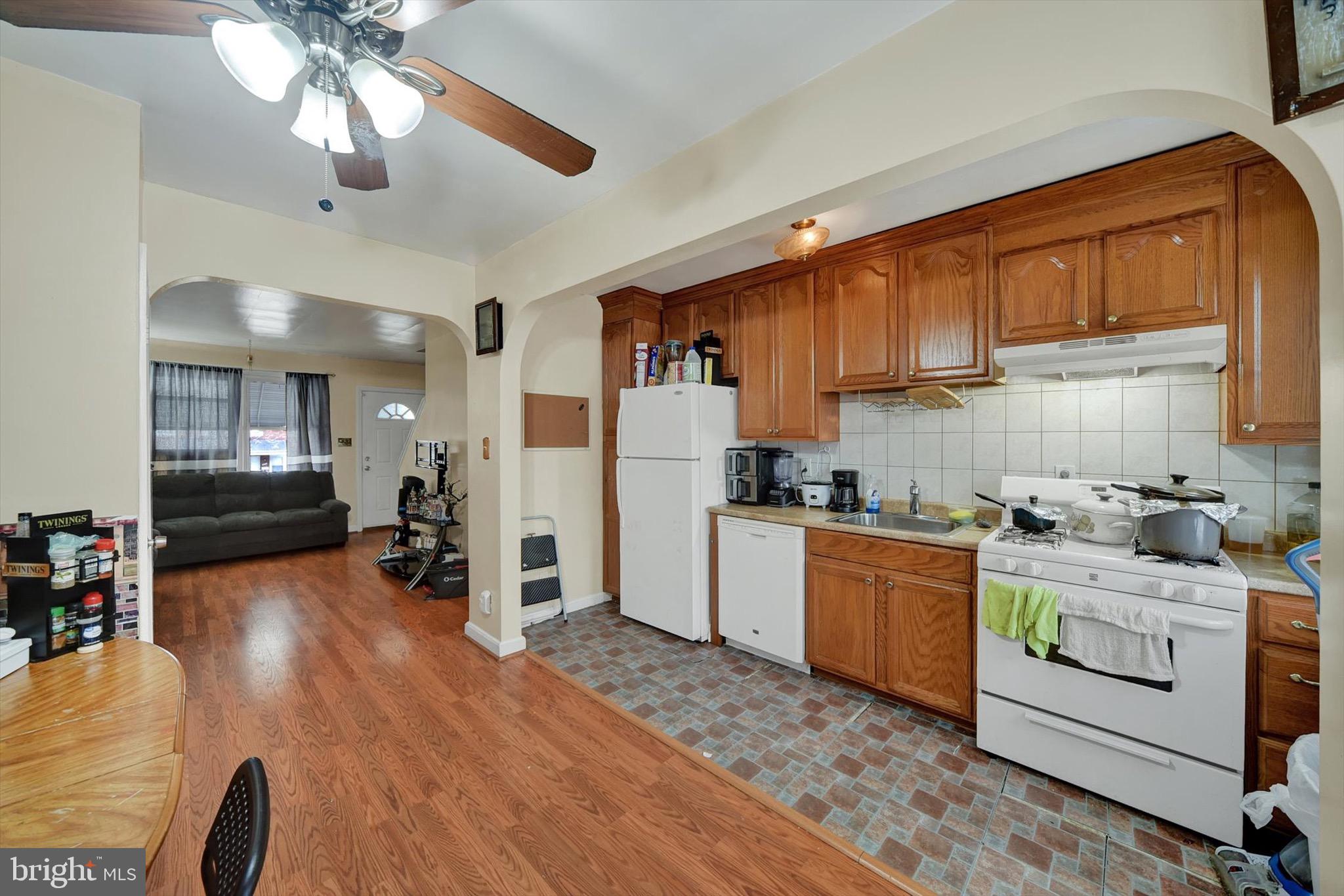 3552 Benzinger Road Baltimore, MD 21229 - Photo 7 of 23 a kitchen with a stove a refrigerator and a sink