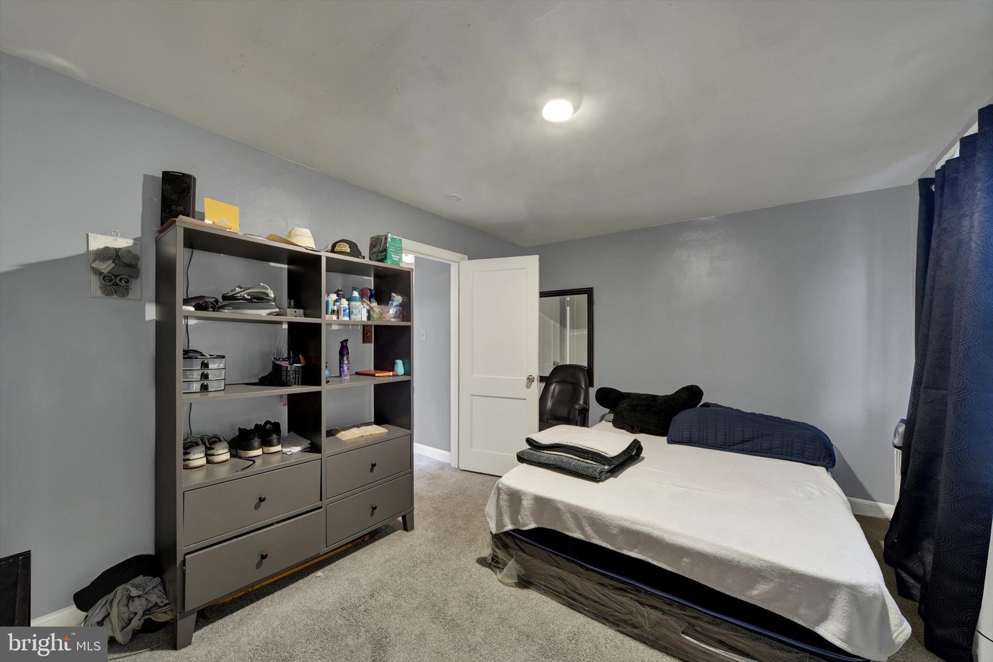 3552 Benzinger Road Baltimore, MD 21229 - Photo 8 of 23 a bedroom with a bed and a window