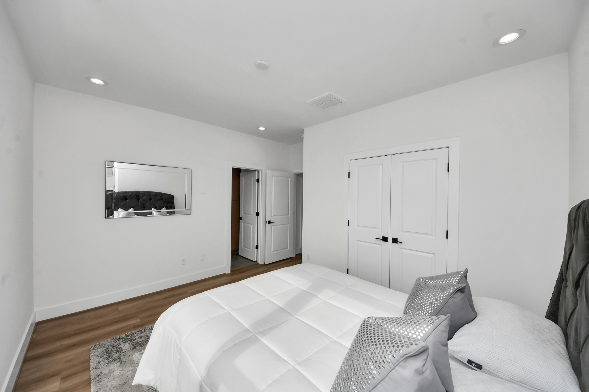 505 Middle Street Houston, TX 77003 - Photo 32 of 46 Discover the inviting second-floor bedroom, featuring sleek hardwood floors, soothing white walls, and ample closet space, perfect for a cozy retreat.