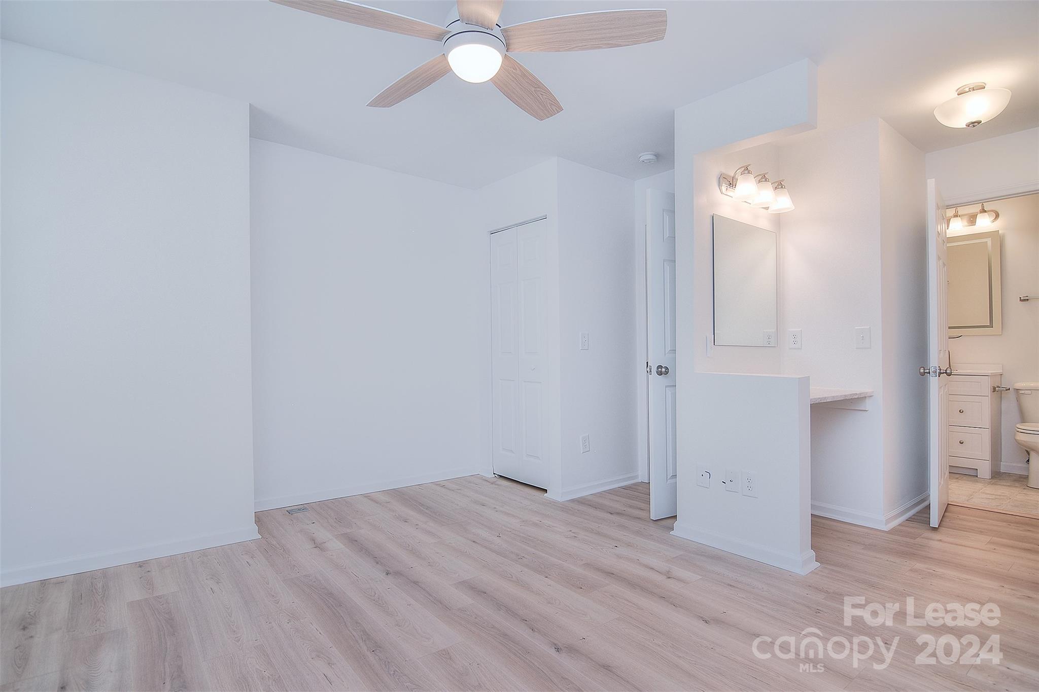 660 Lex Drive Charlotte, NC 28262 - Photo 12 of 16 an empty room with wooden floor and fan