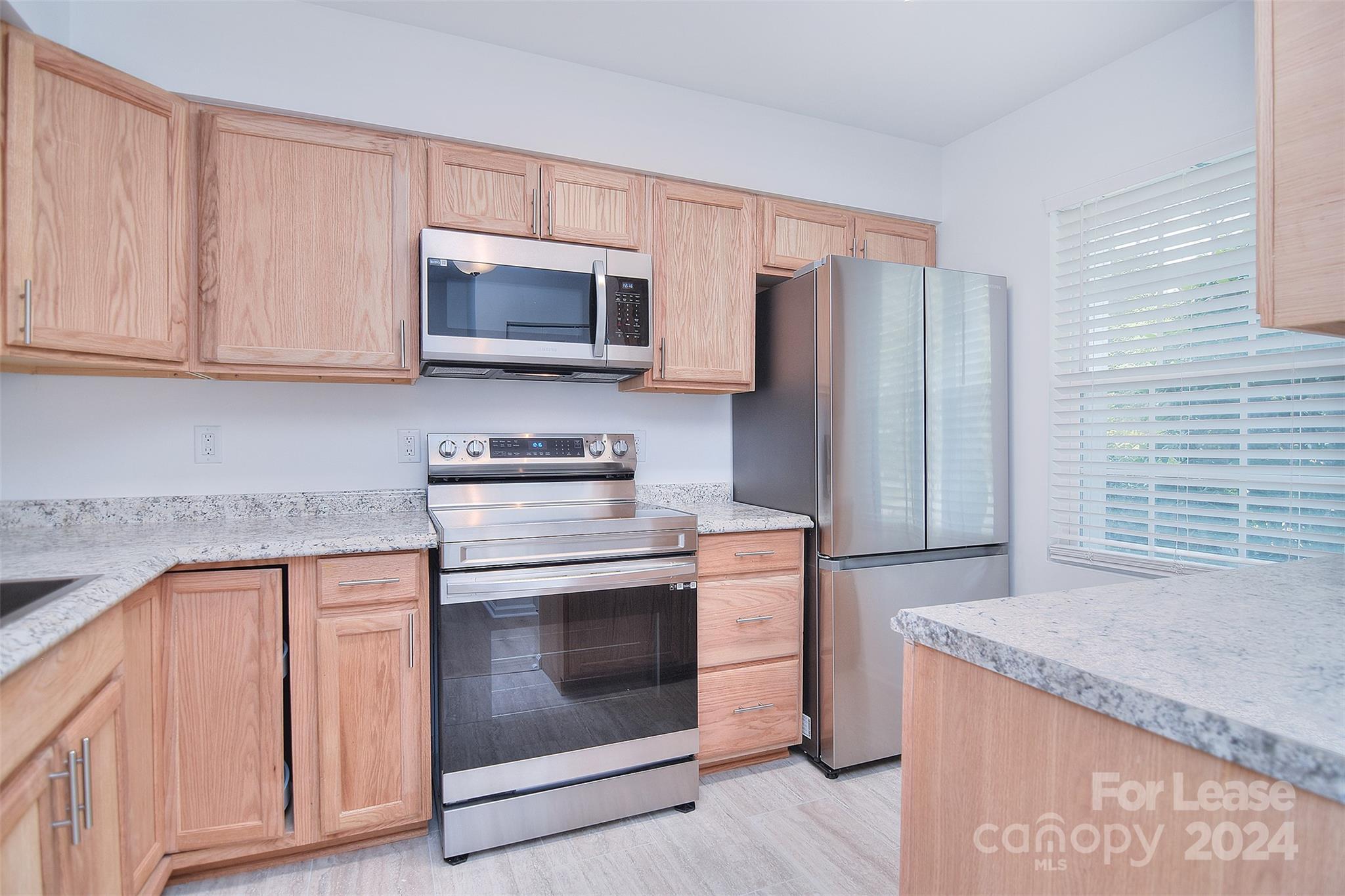 660 Lex Drive Charlotte, NC 28262 - Photo 7 of 16 a kitchen with granite countertop a stove top oven microwave and cabinets