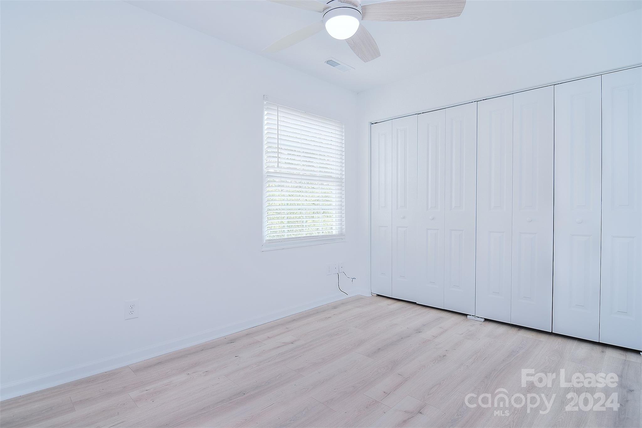 660 Lex Drive Charlotte, NC 28262 - Photo 9 of 16 wooden floor in an empty room with a window
