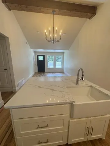 a bathroom with a sink and a chandelier