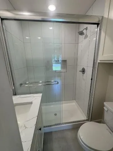 a bathroom with a shower and a toilet