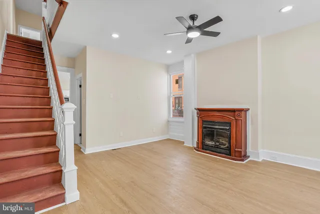 wooden floor in an empty room with a fireplace