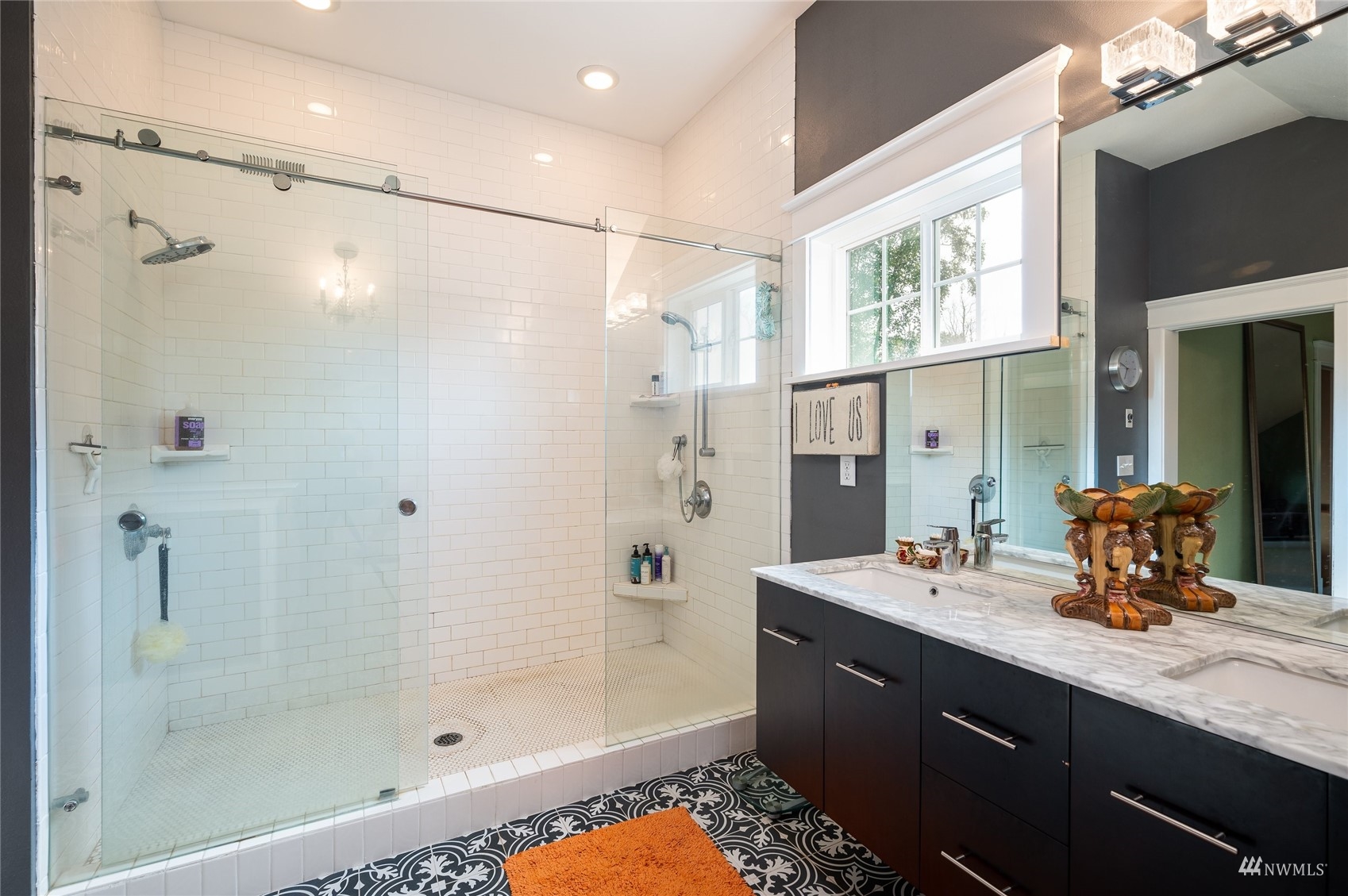 4648 Curtis Road Bellingham, WA 98226 - Photo 24 of 39 a bathroom with a double vanity sink a large mirror and shower