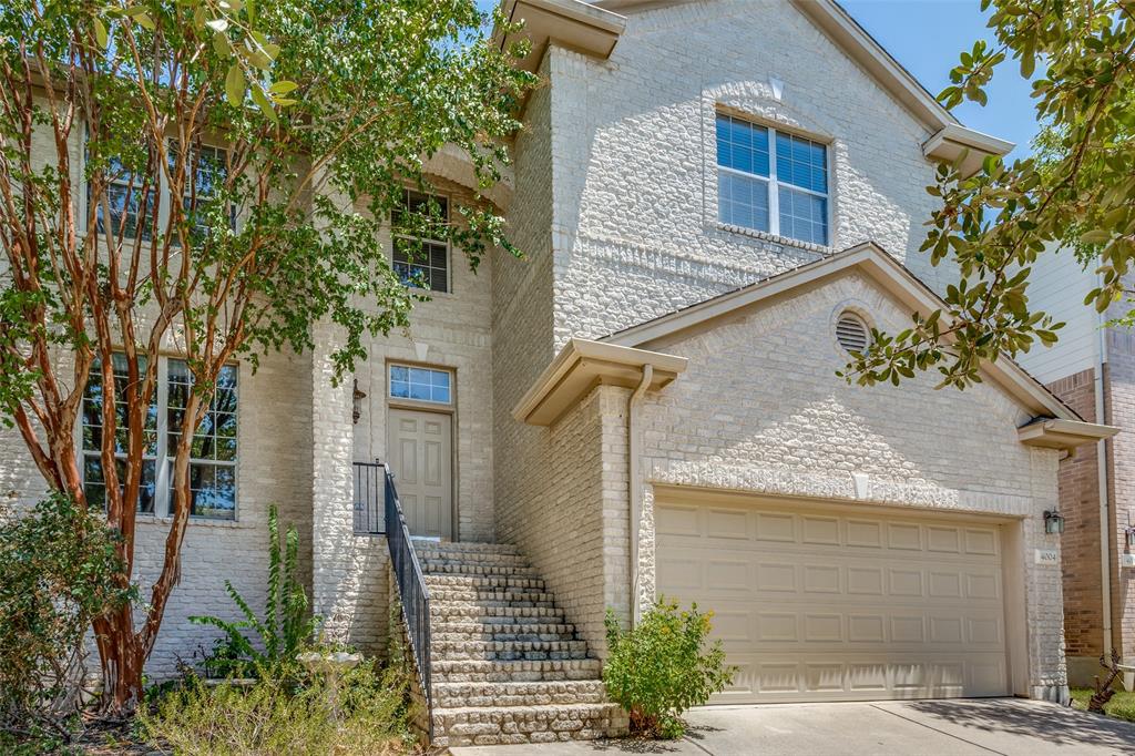 a view of a house with a tree