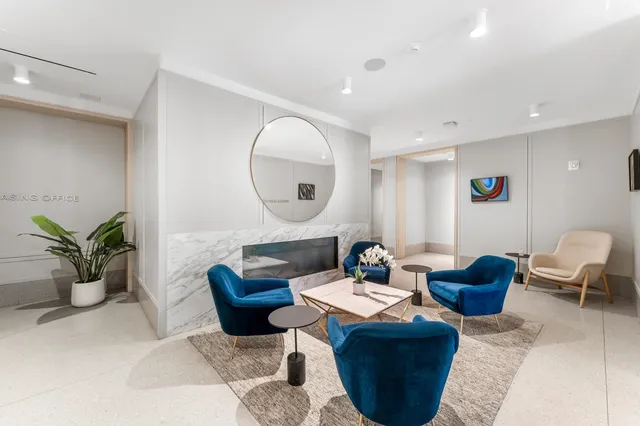 a living room with furniture and a large mirror