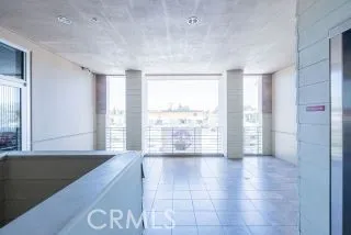an empty room with kitchen and entrance